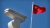CHINA -- A Chinese flag flies near a Hikvision security camera monitoring a traffic intersection in Beijing, October 8, 2019