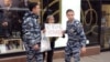 Russia -- Moscow policemen arrest Irina Epifanovskaya, civil activist, taking part in action against Russia taking part in war in Ukraine, 31 August 2014
